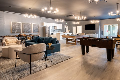 a large living room with a pool table and couches